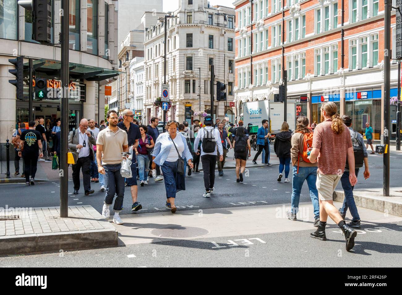 Pedestrians crossing at the intersection of High Holborn and Southampton Row in Central London, UK Stock Photo