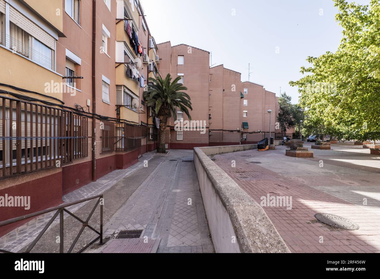 Access area and promenade of a modest and old urban housing development Stock Photo