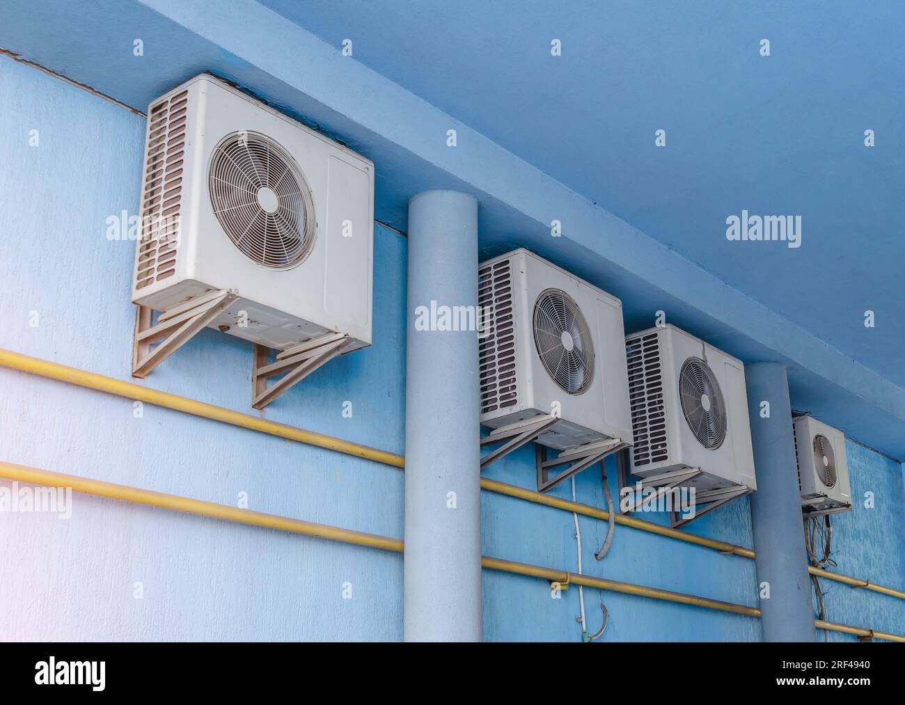 White air conditioners on blue wall of the house. Modern climate