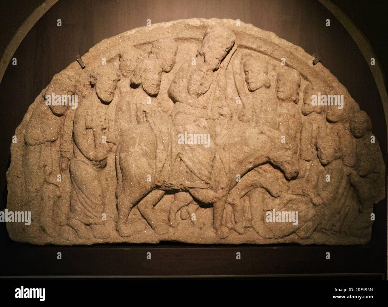 Semi circular stone carved depiction of Jesus on a donkey surrounded by the 12 disciples in the cathedral museum Santiago de Compostela Galicia Spain Stock Photo