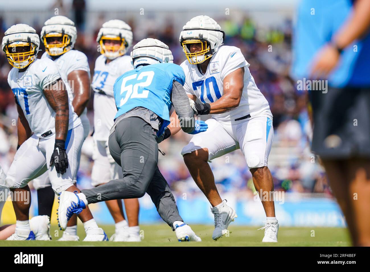 Los Angeles Chargers offensive tackle Rashawn Slater (70) and linebacker  Khalil Mack (52) participate in drills