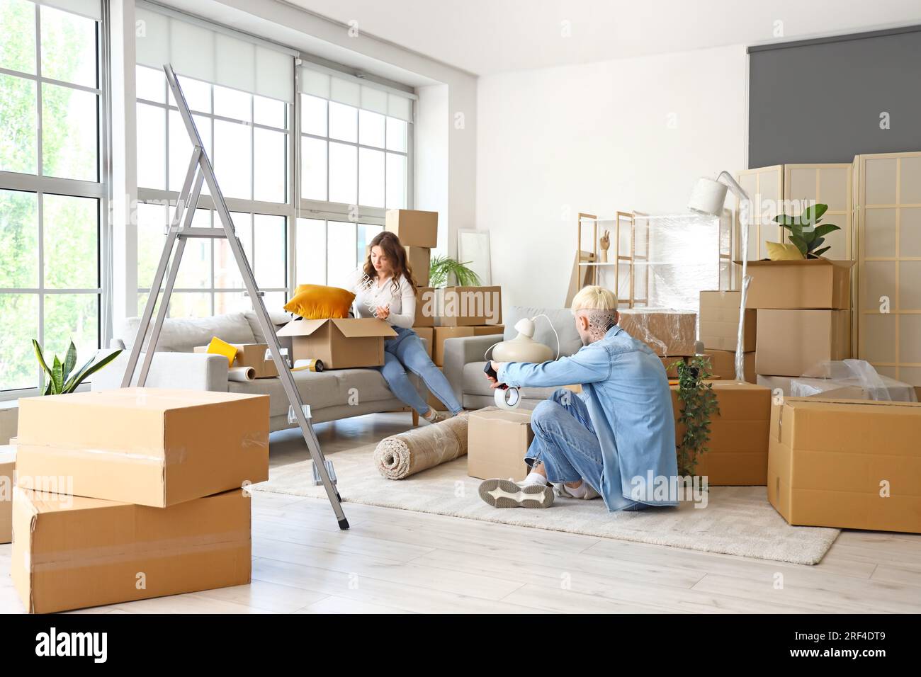 Young couple packing things in room on moving day Stock Photo