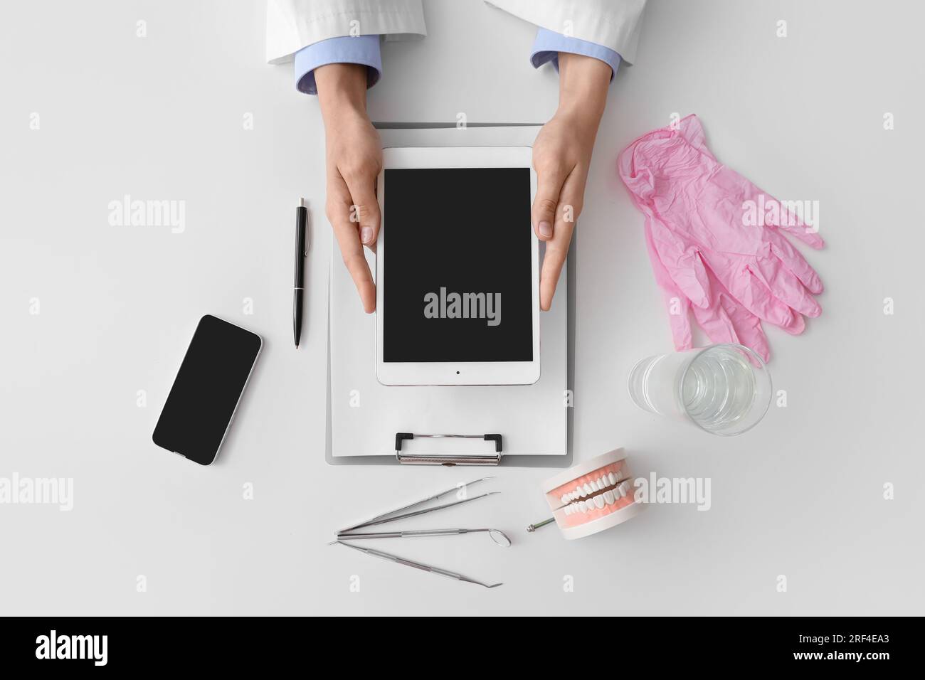 Doctor working with tablet computer on white table Stock Photo