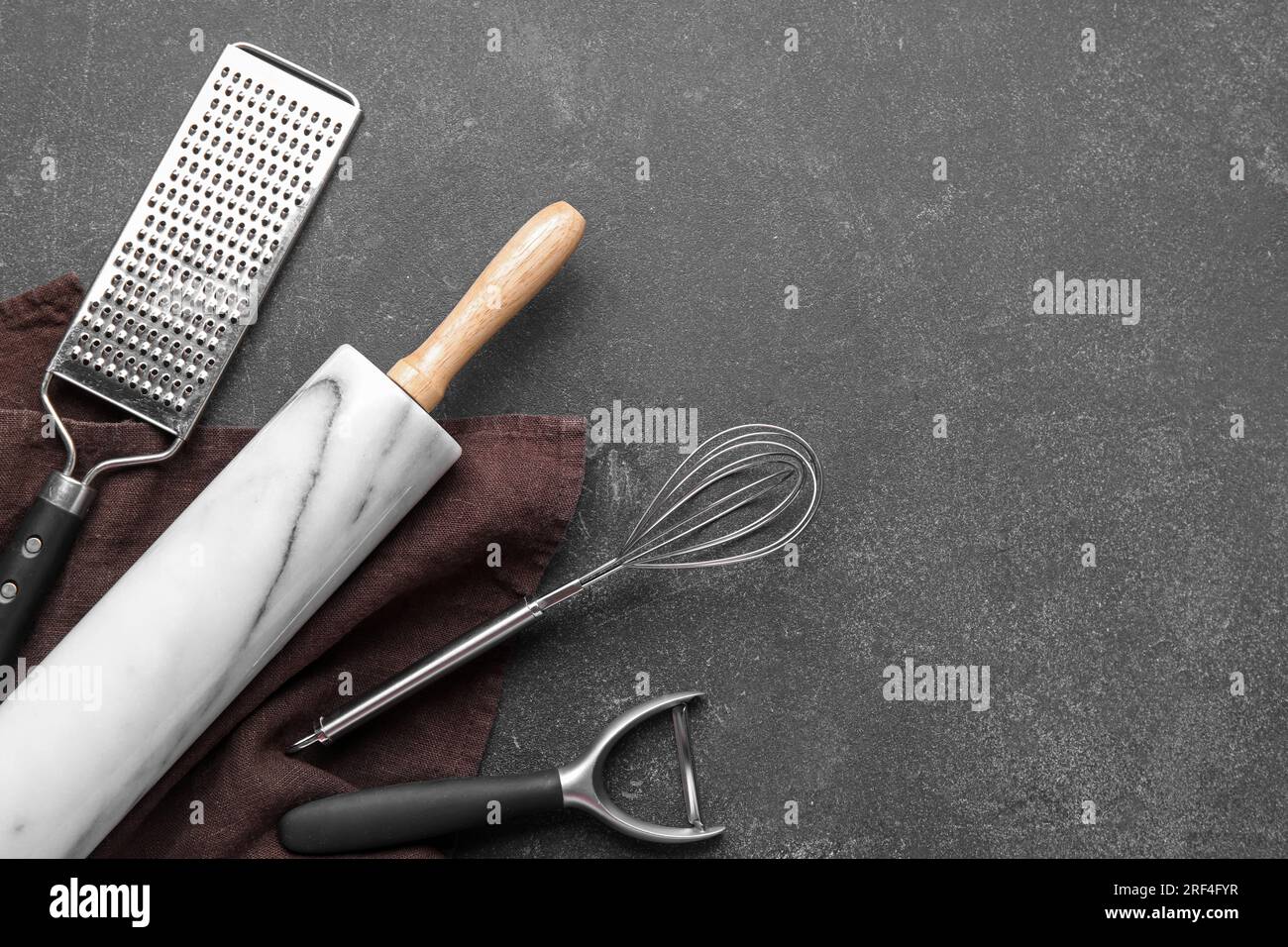 Set of different kitchen utensils on dark background Stock Photo