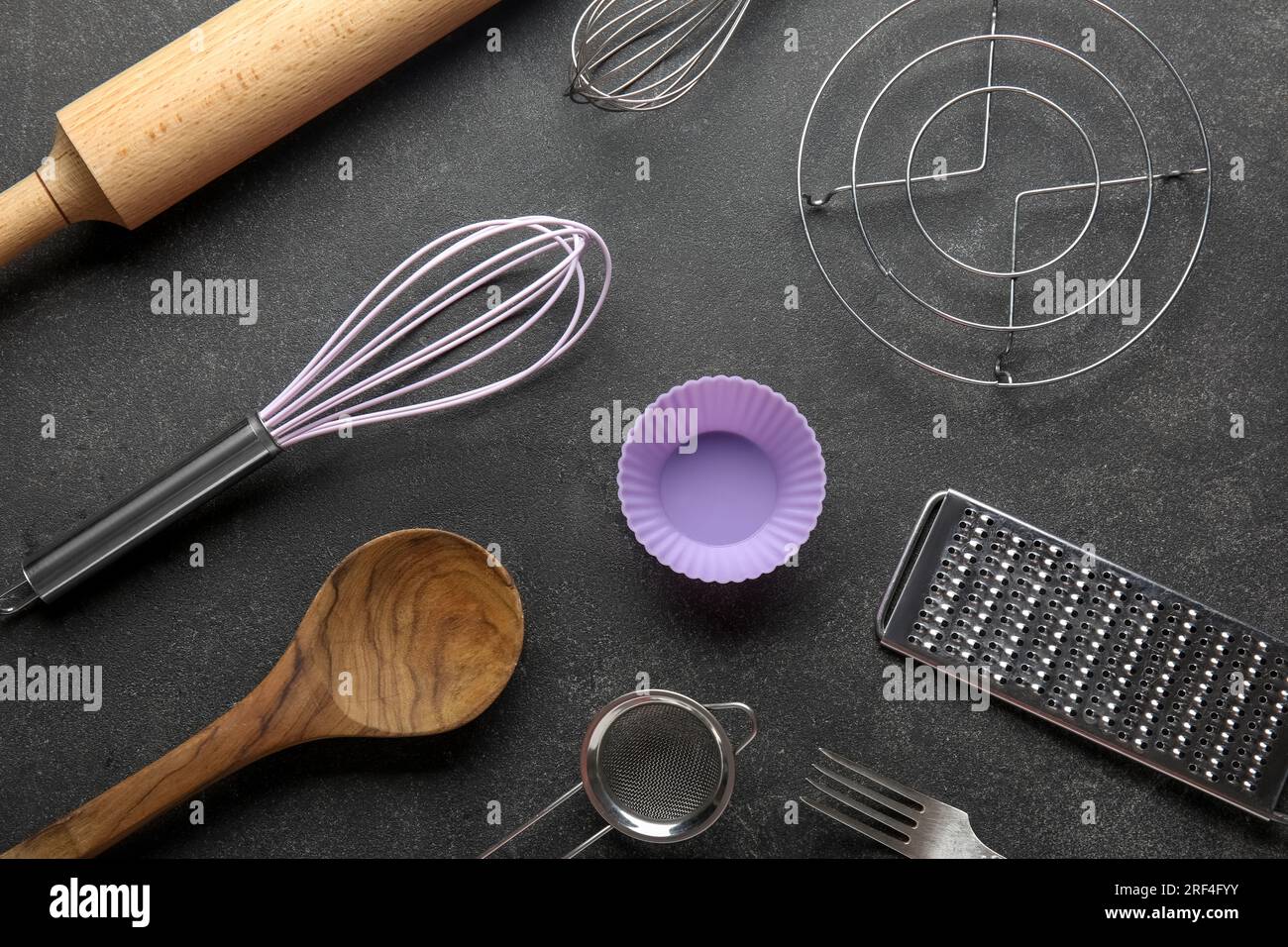 Set of different kitchen utensils on dark background Stock Photo