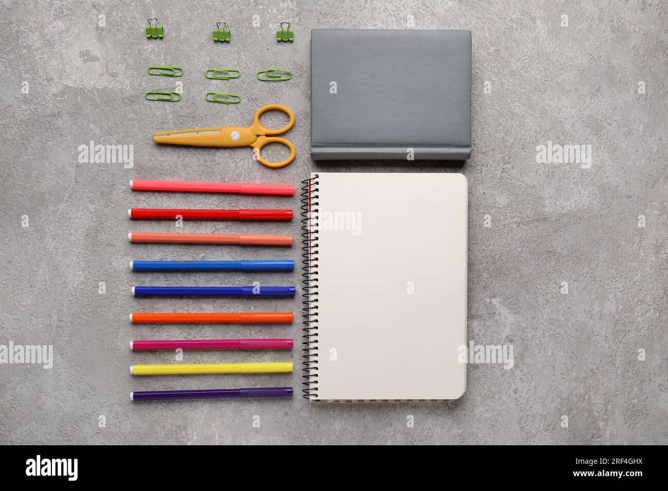Composition with notebooks, scissors and felt-tip pens on grunge background Stock Photo