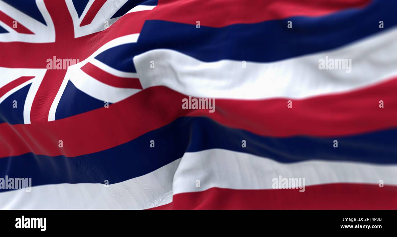 Closeup of the Hawaii state flag waving in the wind. Eight horizontal