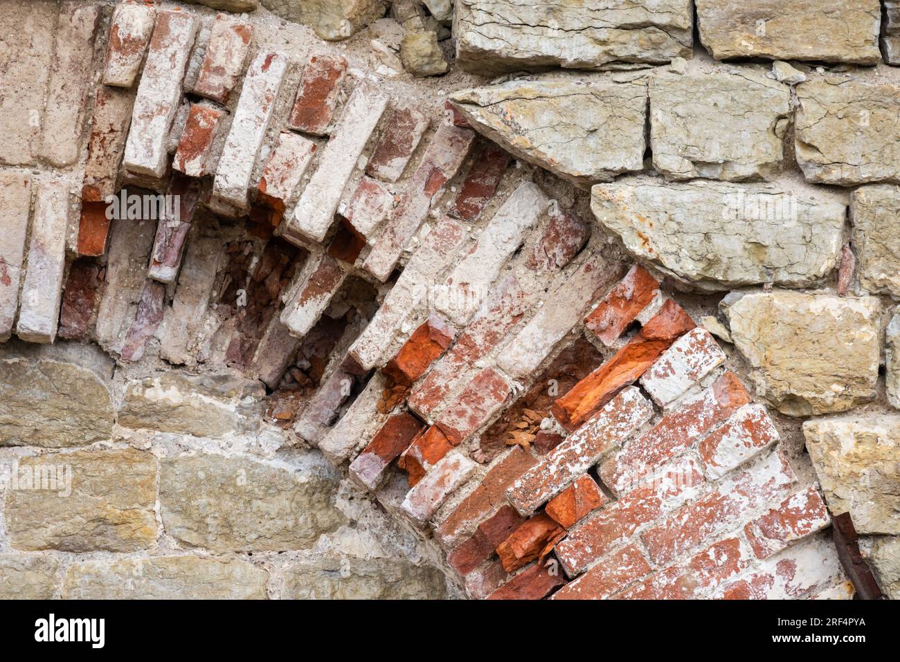 Old brick wall with broken arch, ancient Orthodox church exterior fragment Stock Photo