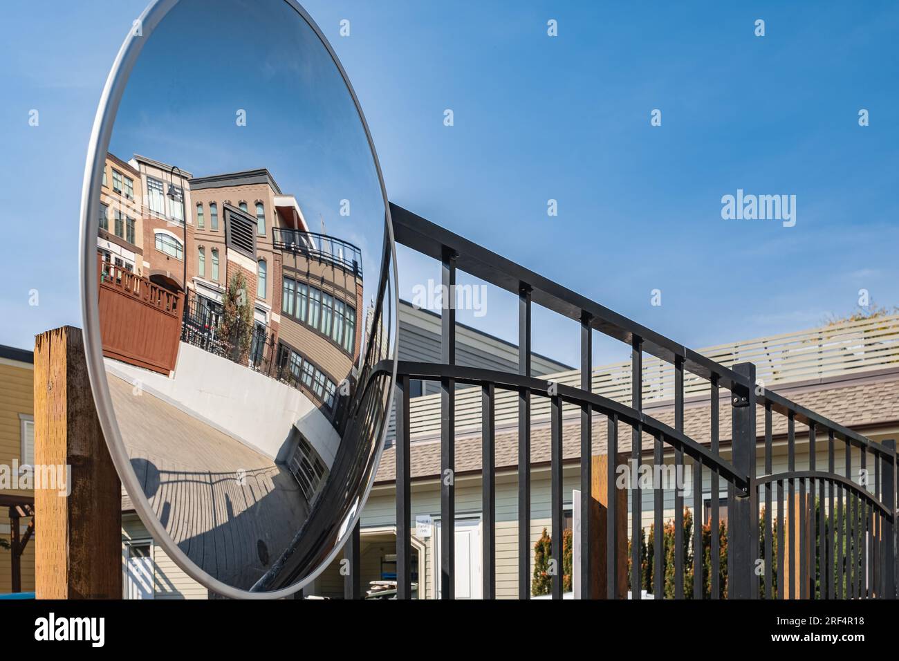 Round mirror for inspection. A viewing mirror in the parking lot. A spherical large convex mirror on the street road for improving visibility. Convex Stock Photo