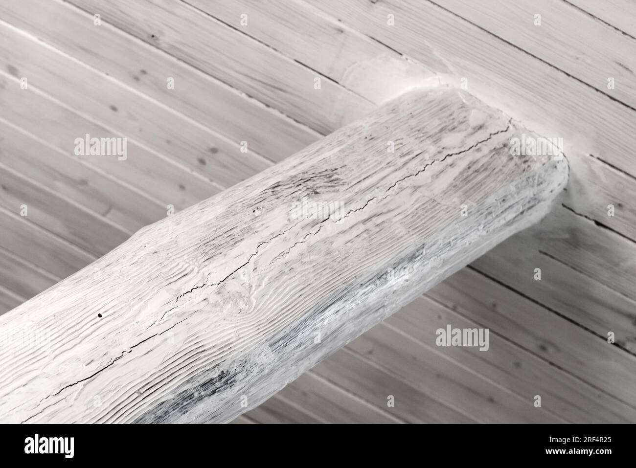 White ceiling beam made from stained oak log, closeup photo with selective soft focus Stock Photo