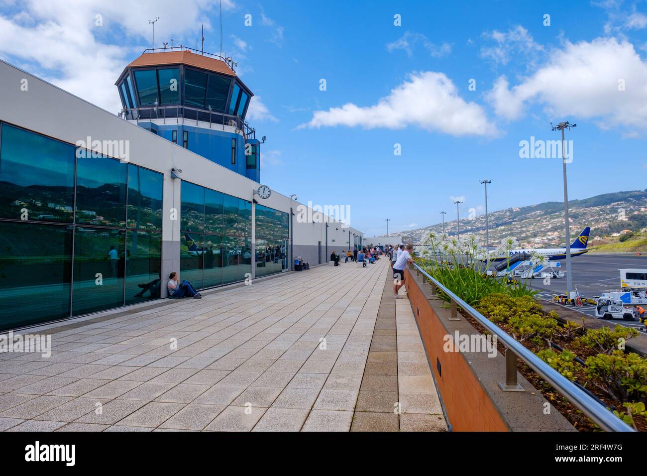 Passengers outside watching the runway planes at Madeira Airport, control tower, Madeira Island archipelago, Funchal, Portugal Stock Photo
