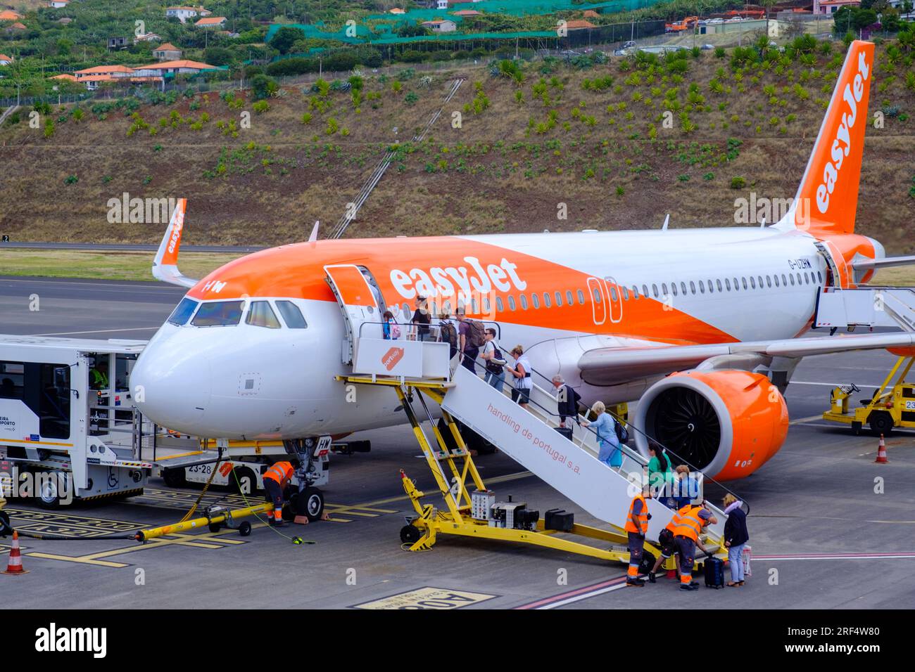 Air travel, Easyjet plane, passengers in queue boarding an Easyjet Airbus A320-251N at the tarmac, Madeira Island Airport, Funchal, Portugal Stock Photo