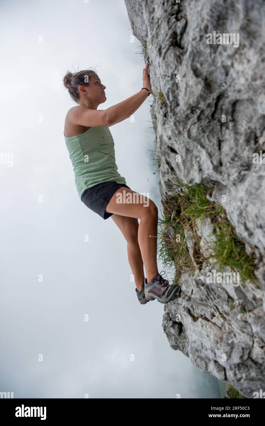 Girl climbing the mountain without safety rope Stock Photo Alamy
