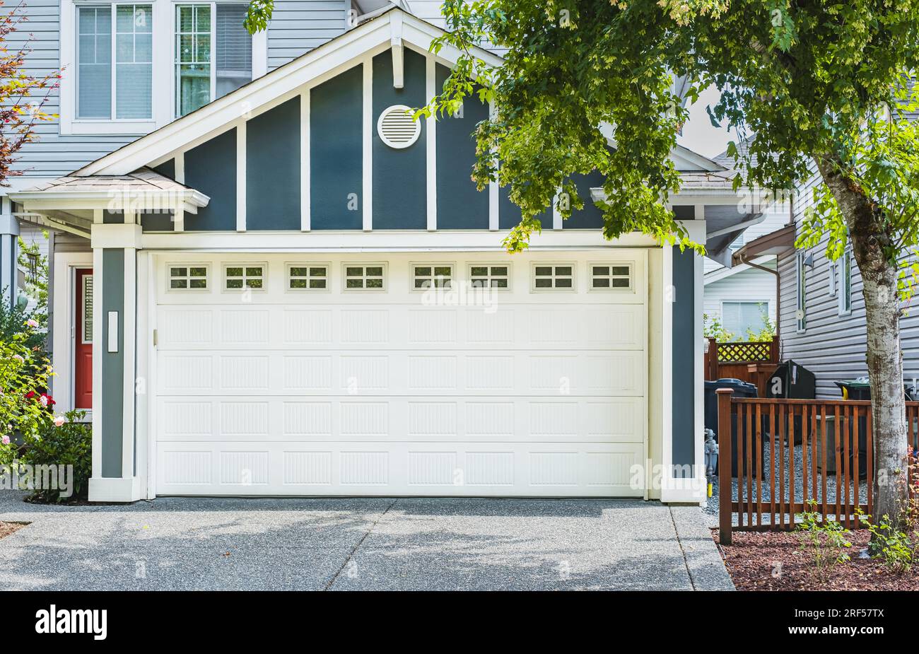 White Garage door with driveway in Vancouver, Canada. Garage door in