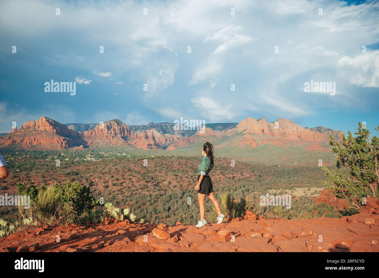 Young hiker woman on the edge of a cliff at Cathedral Rock in Sedona ...