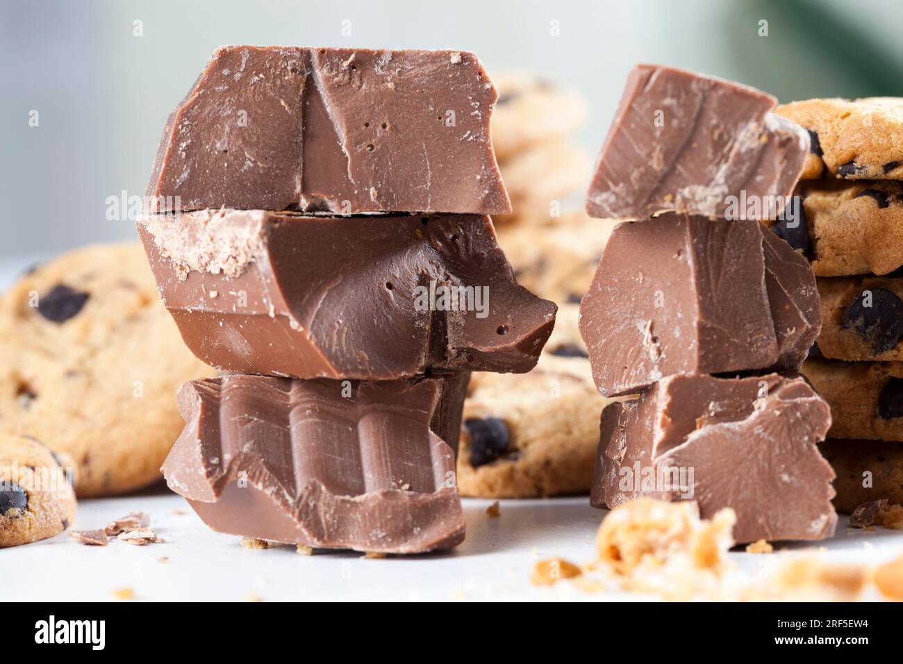 pieces of sweet chocolate together with cookies with pieces of chocolate inside as a filling, cookies with chocolate close up, cookies made of flour Stock Photo