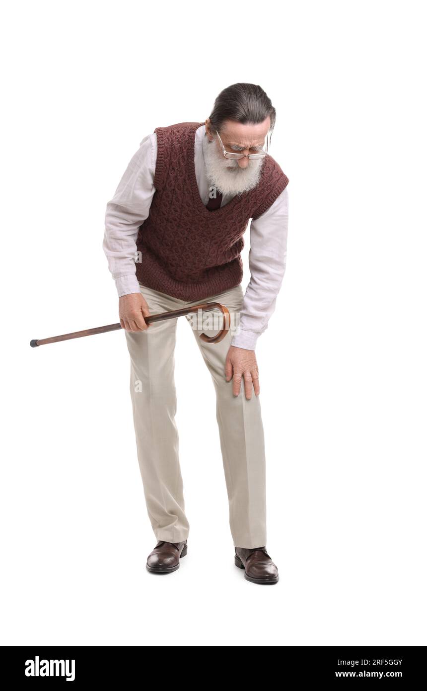 Senior man with walking cane suffering from knee pain on white