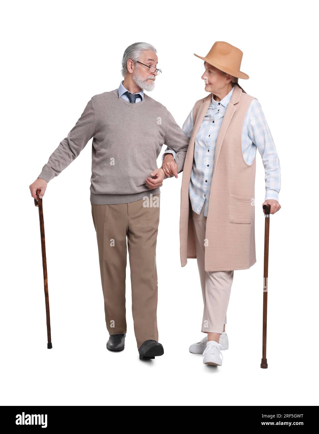 Senior man and woman with walking canes on white background Stock Photo ...