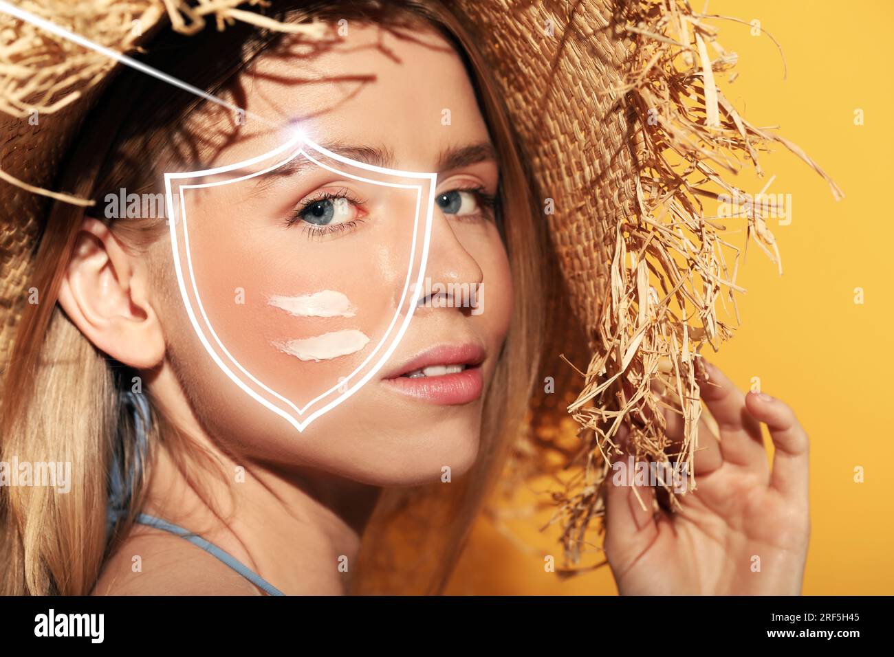 Sun protection care. Beautiful woman with sunscreen on face against