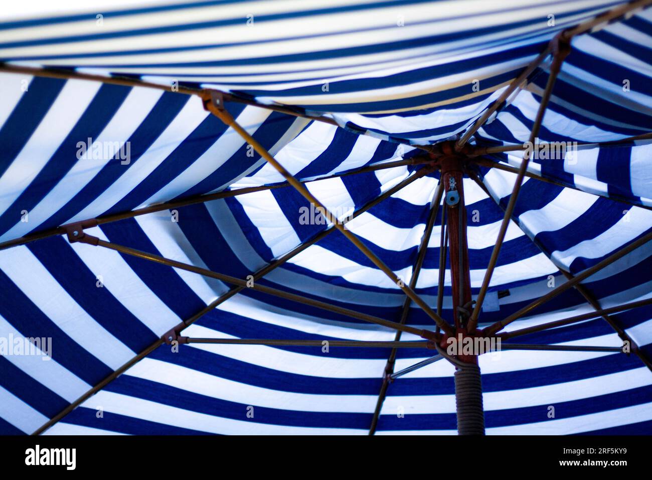Blue and white striped umbrella Stock Photo - Alamy