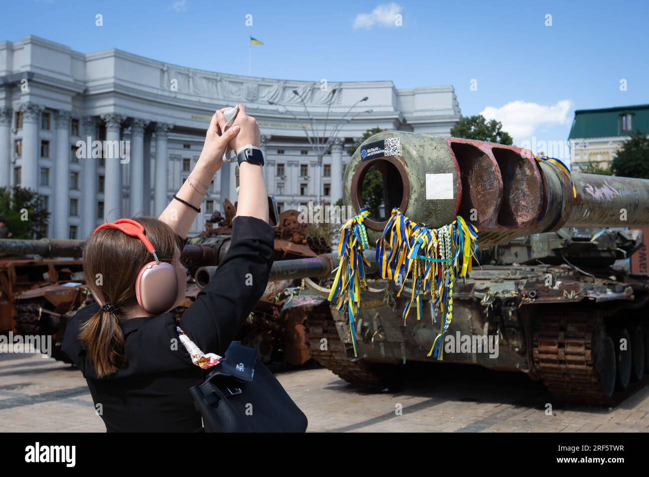 Kyiv, Ukraine. 28th July, 2023. A girl takes a photo of a a destroyed Russian tank on display in central Kyiv. Credit: SOPA Images Limited/Alamy Live News Stock Photo