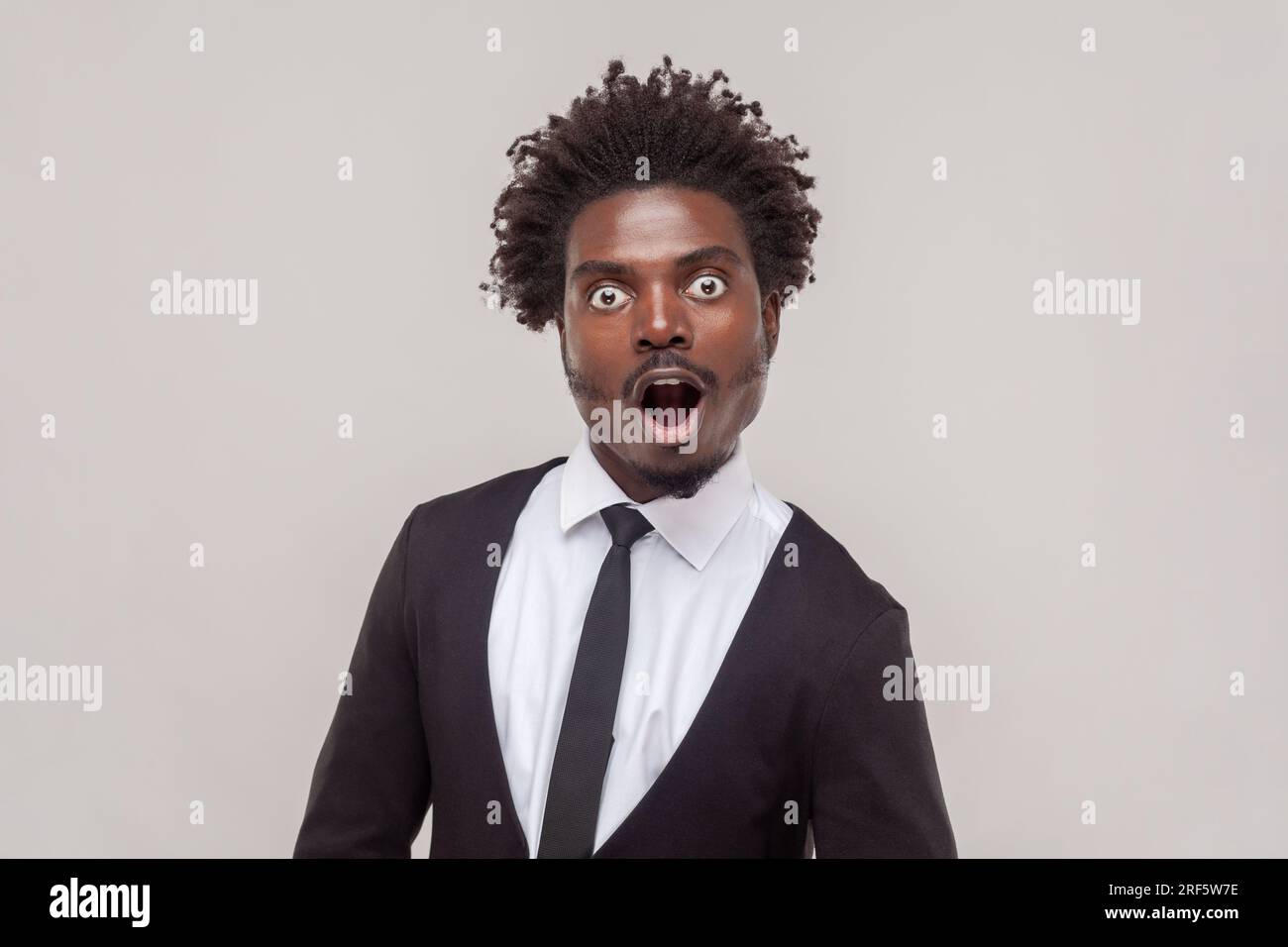 Shocked man with Afro hairstyle stares bugged eyes, feels anxious ...