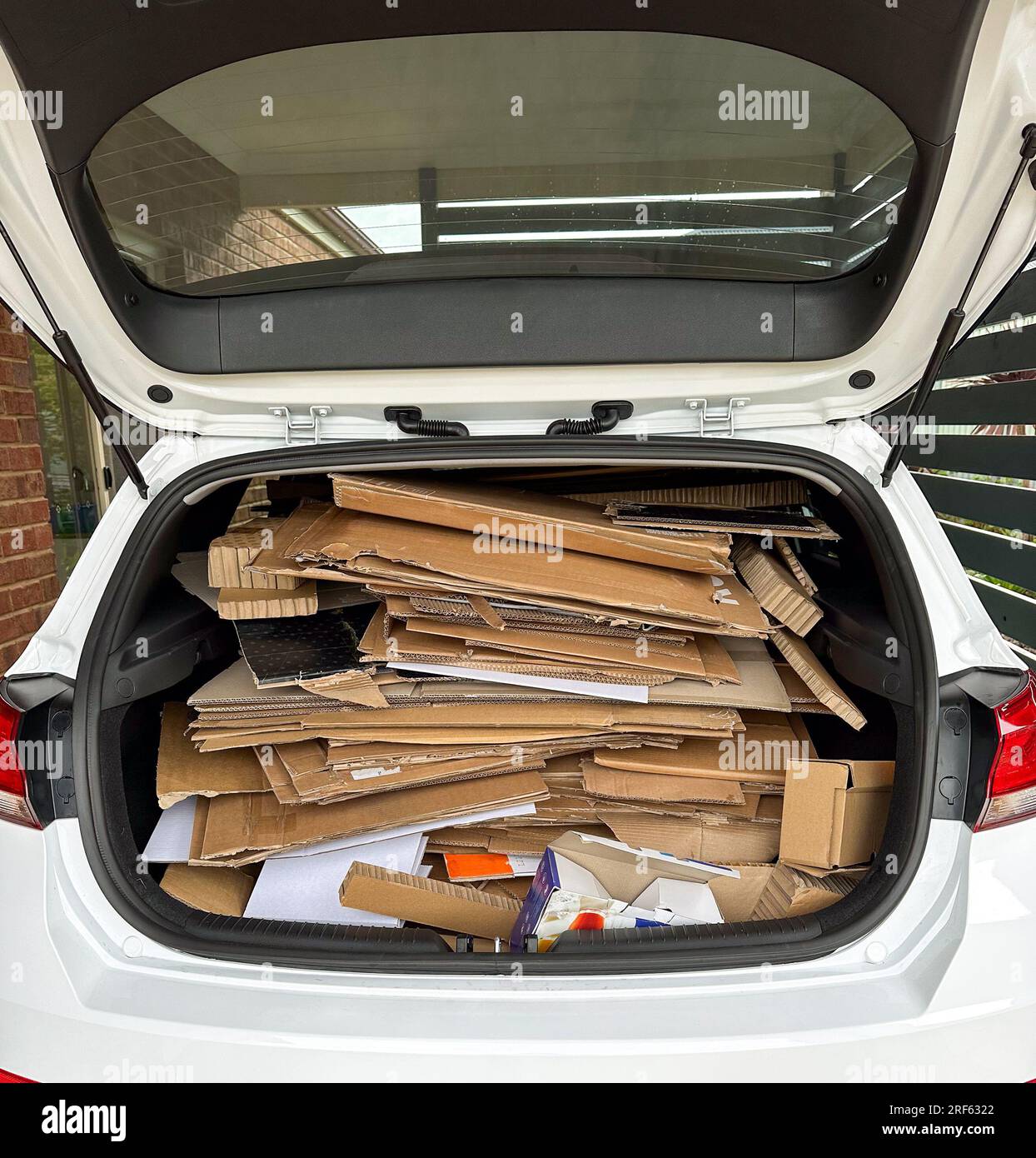 Concept of a trunk full of stacked cardboard to be taken to recycling depot Stock Photo