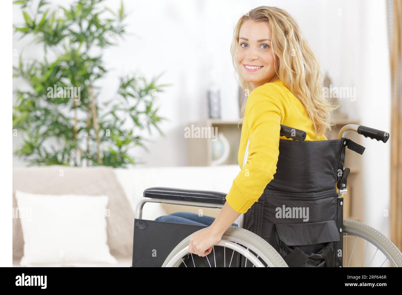 happy woman on wheelchair smiling at home Stock Photo