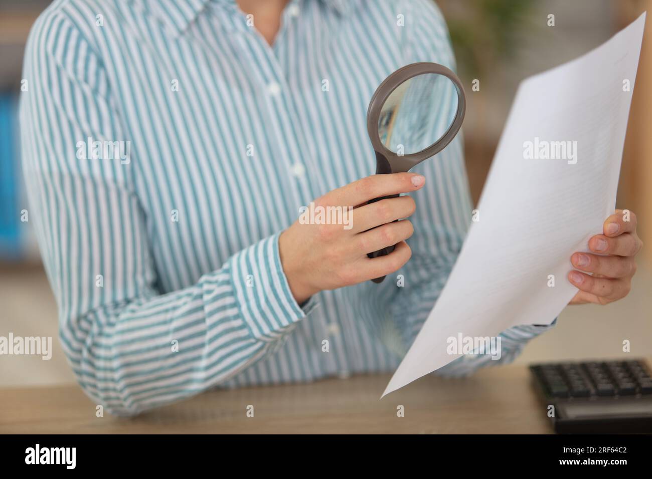 business woman looking into a magnifying glass Stock Photo - Alamy