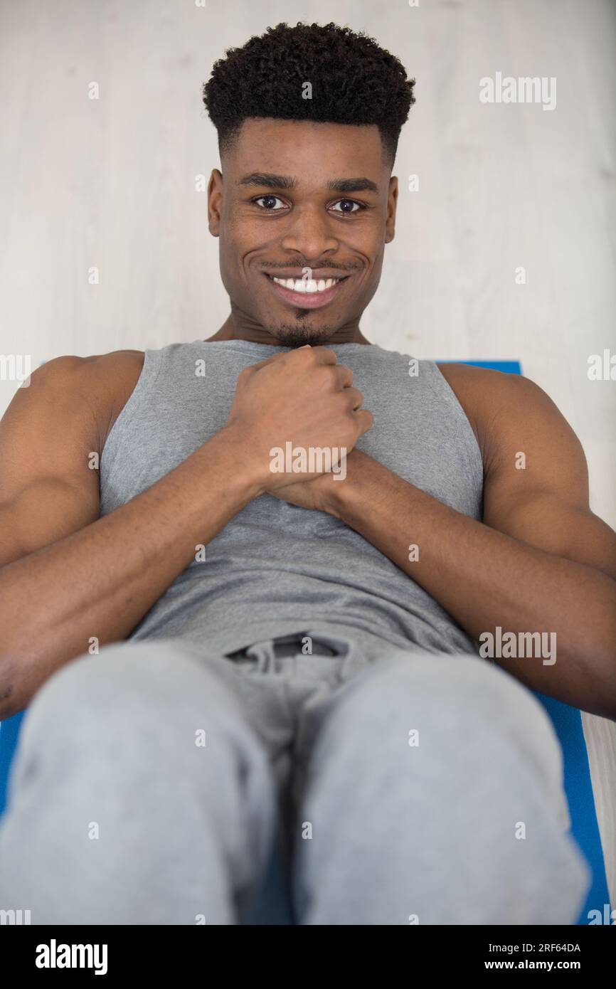 muscular builder man does sit-ups Stock Photo