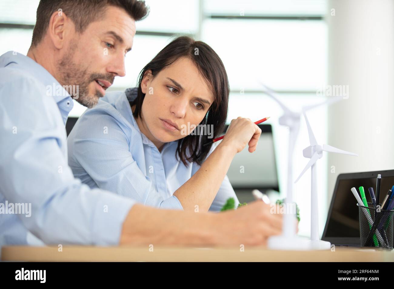 architects studying plans in modern office together Stock Photo