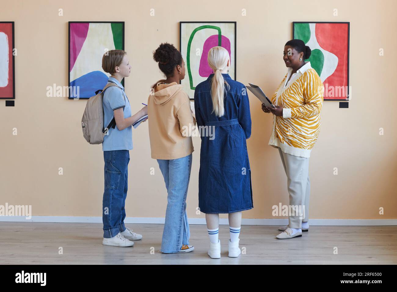 A group of friends taking a prom photo in a museum