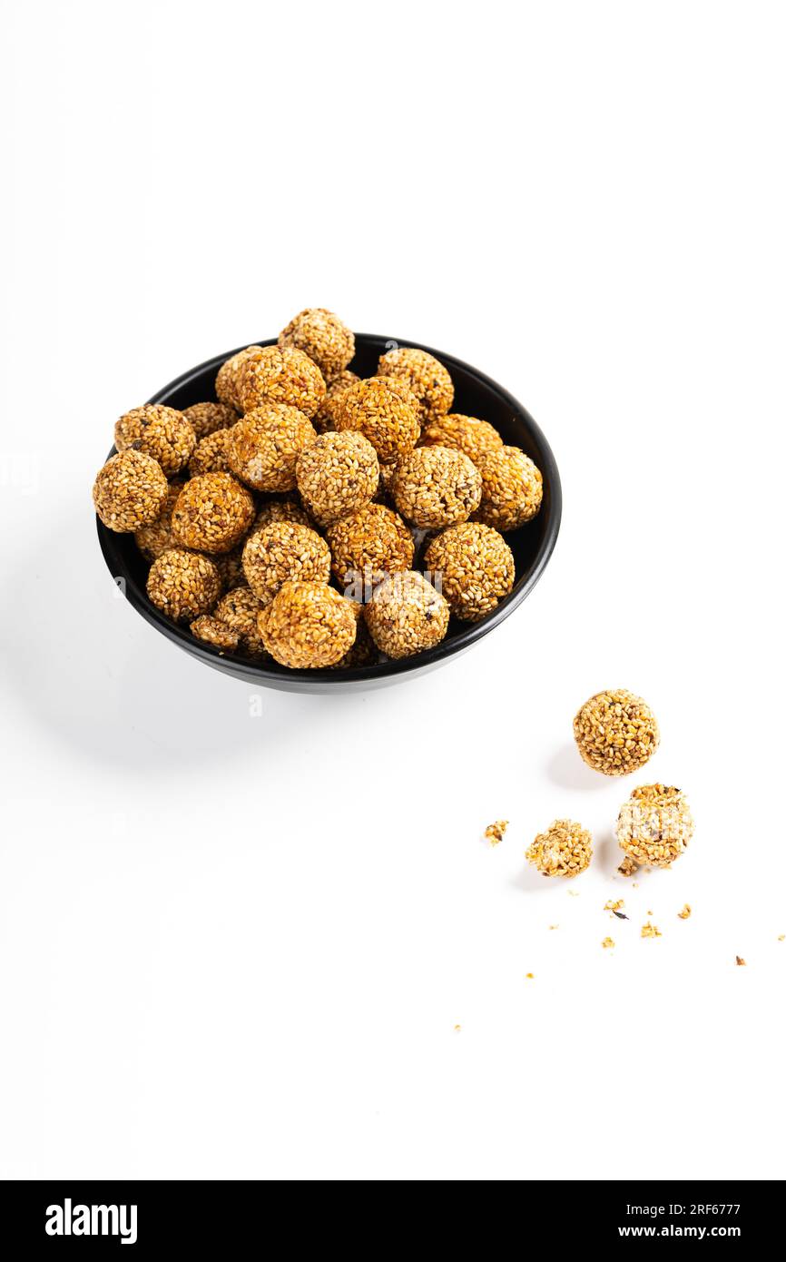 Sesame Ladoo or Ellunda or Til ladoo, a traditional Indian sweet treat made from sesame seeds and jaggery, isolated image with white background. Stock Photo