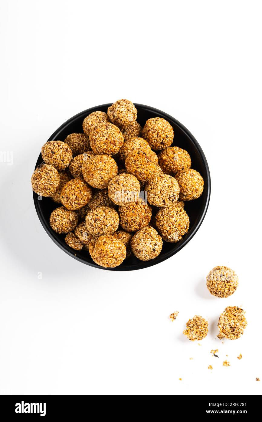 Sesame Ladoo or Ellunda or Til ladoo, a traditional Indian sweet treat made from sesame seeds and jaggery, isolated image with white background. Stock Photo