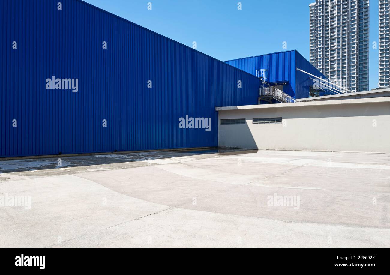 Minimalist composition of dark blue iron wall and concrete floor urban background Stock Photo