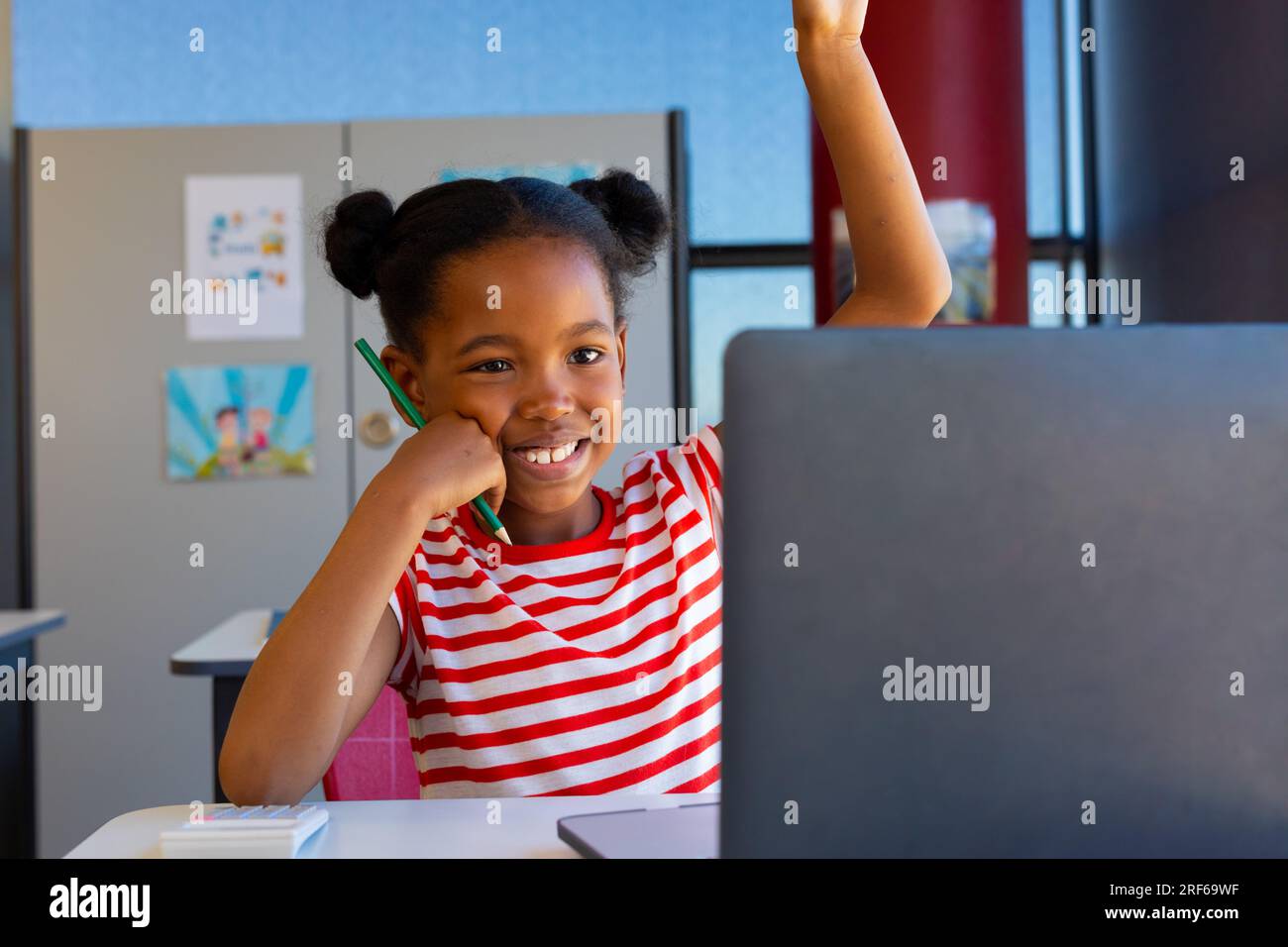 African american girl raising her hand while on video call on laptop in ...