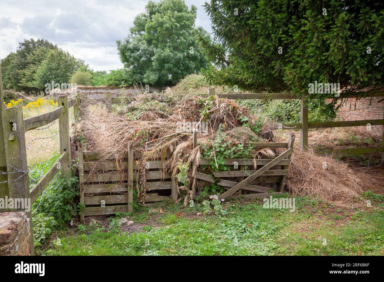 Large compost heap in the corner of a large garden, UK Stock Photo Alamy