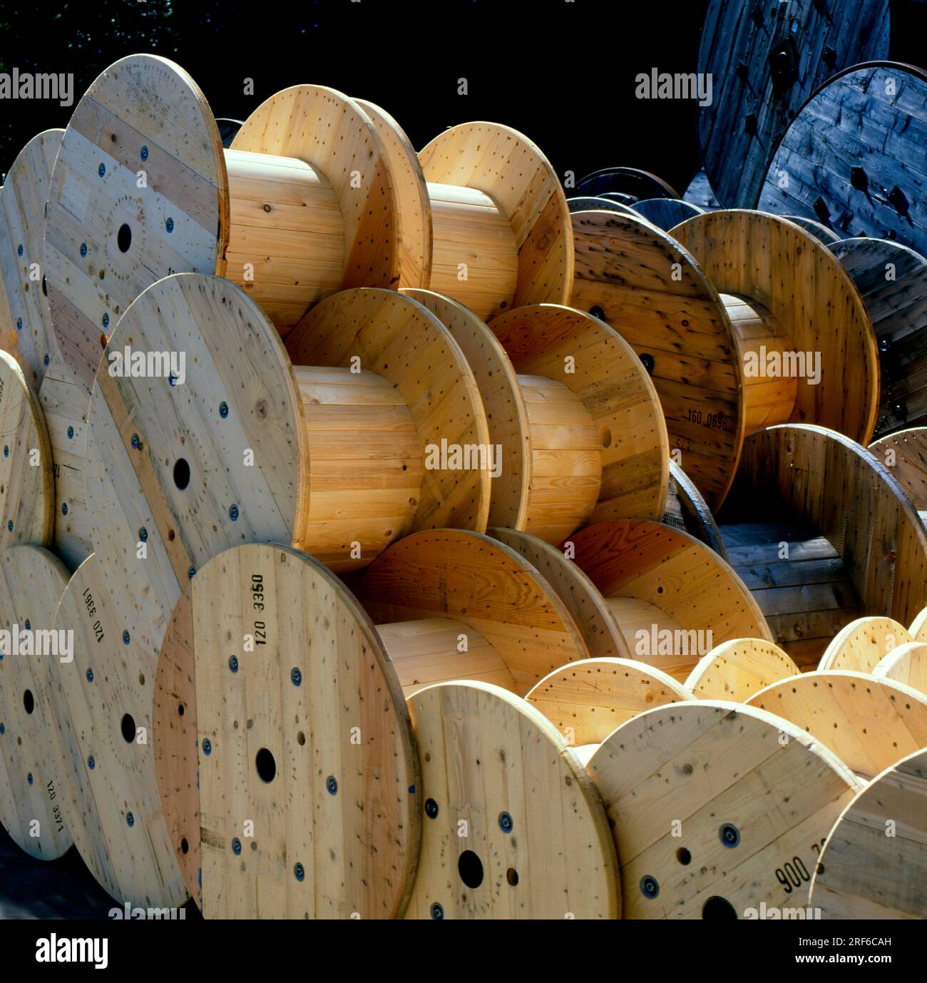 Wooden cable reels, stack, sawmill Stock Photo - Alamy