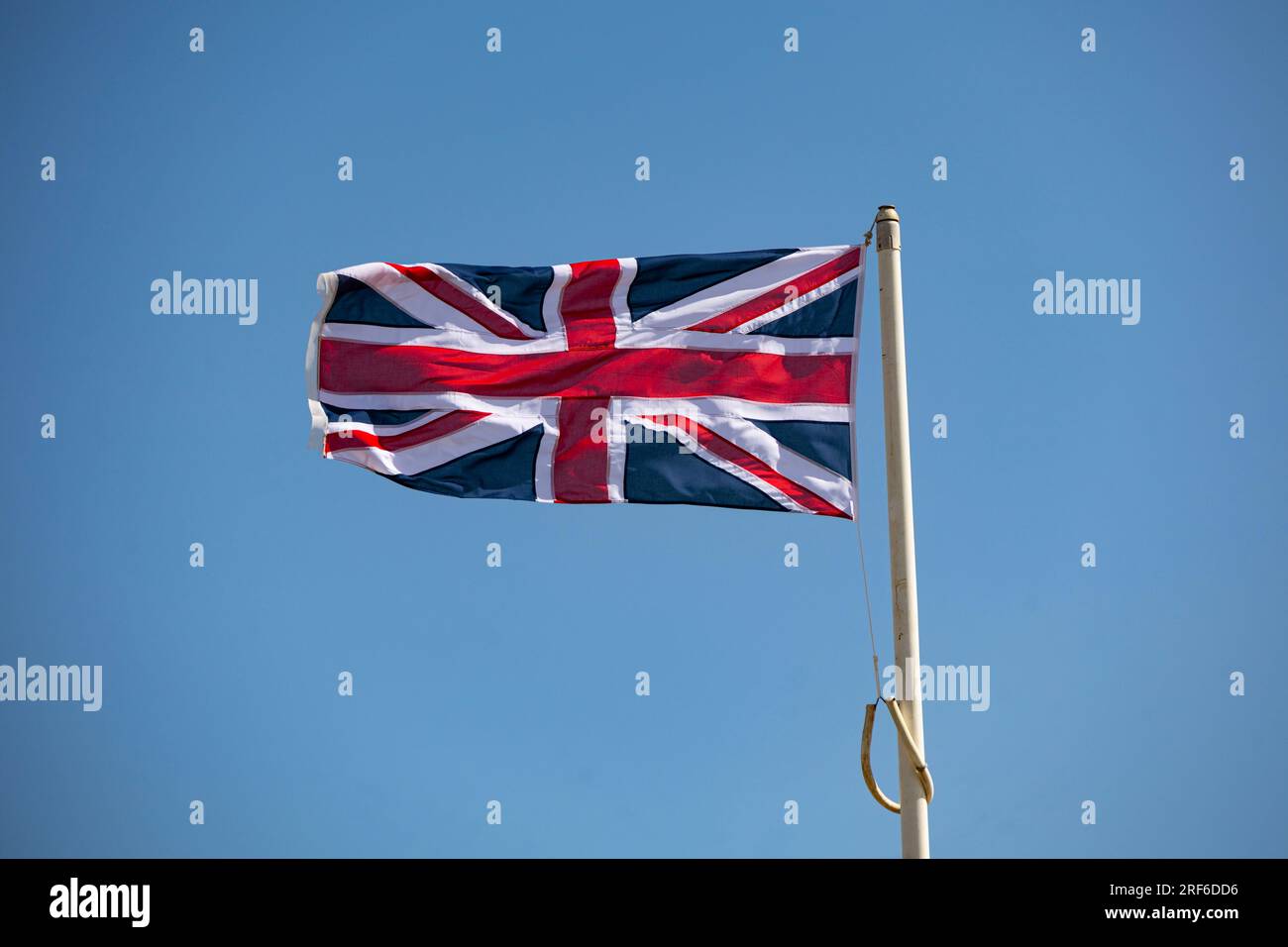 Union flag blowing in the wind, Worthing, West Sussex, UK Stock Photo