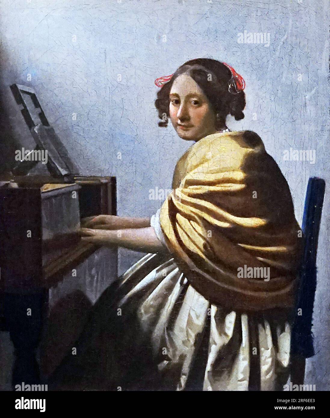 Young Woman Seated at a Virginal by Johannes Vermeer Jan Vermeer 1632 - 1675.Dutch Baroque Period painter. Stock Photo