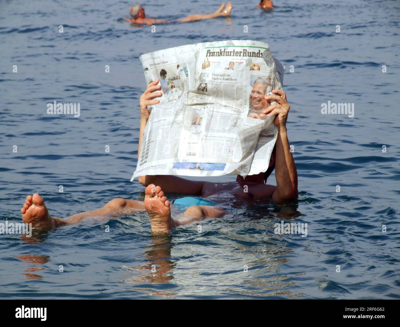 Man reading newspaper, Dead Sea, Jordan Stock Photo - Alamy