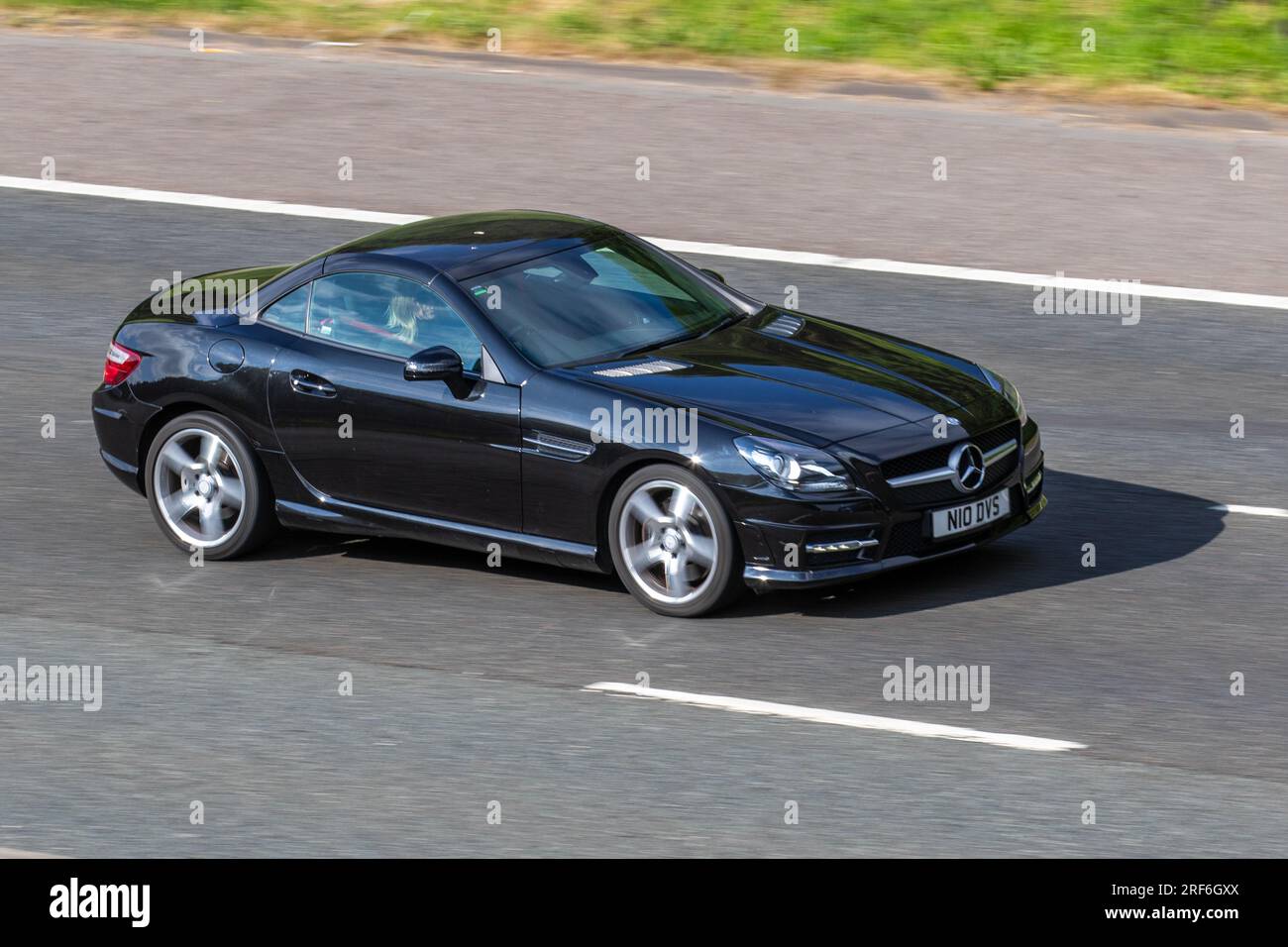 2016 Mercedes-Benz Slk 250 D Amg Sport Auto Slk250d 9G-Tronic Auto Start/Stop Black Car Roadster Diesel 2143 cc travelling at speed on the M6 motorway in Greater Manchester, UK Stock Photo