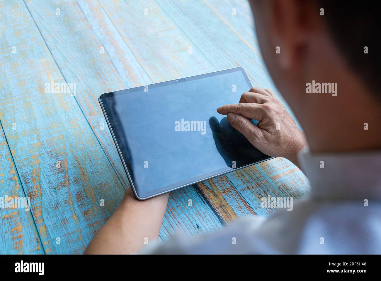Man using digital tablet by touchscreen. Copy space. Stock Photo