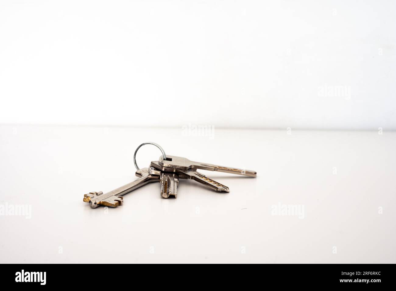 Four metal keys with circle bunch. Housing, open door, metal Stock Photo
