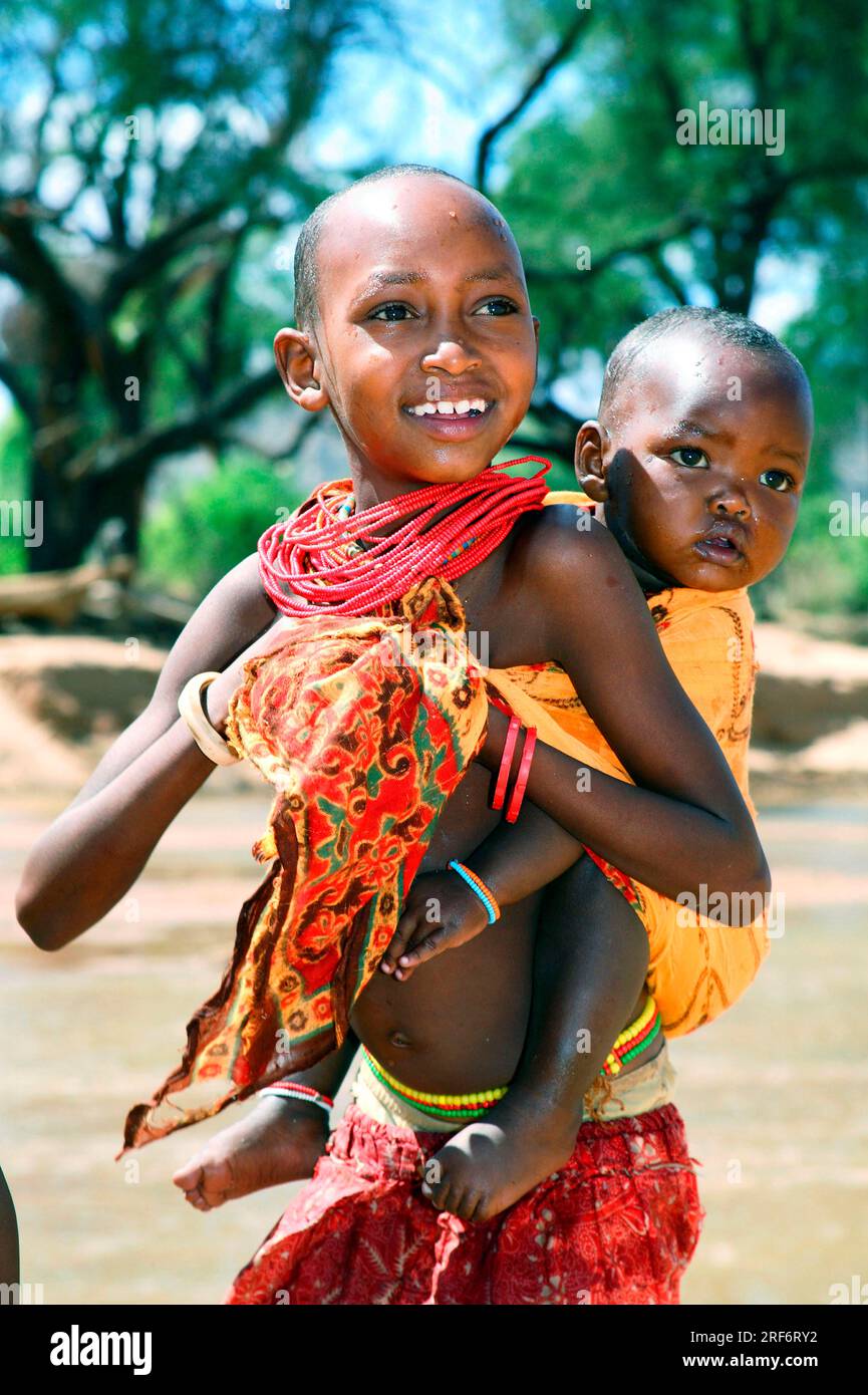 Samburu girl with baby in sling, Samburu tribe, Samburu National Park ...