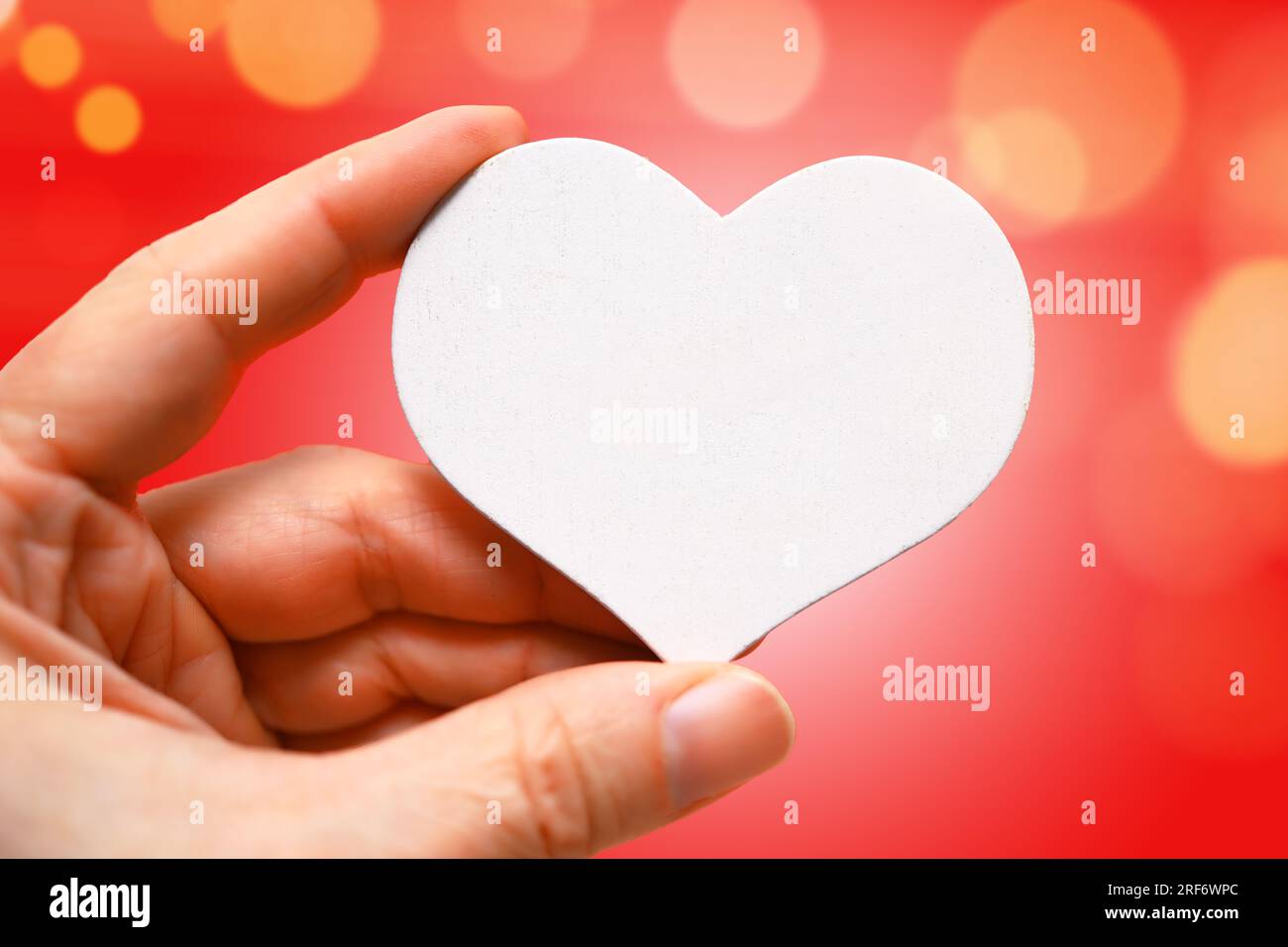 Hand hält weißes Herz, Symbolfoto Valentinstag Stock Photo