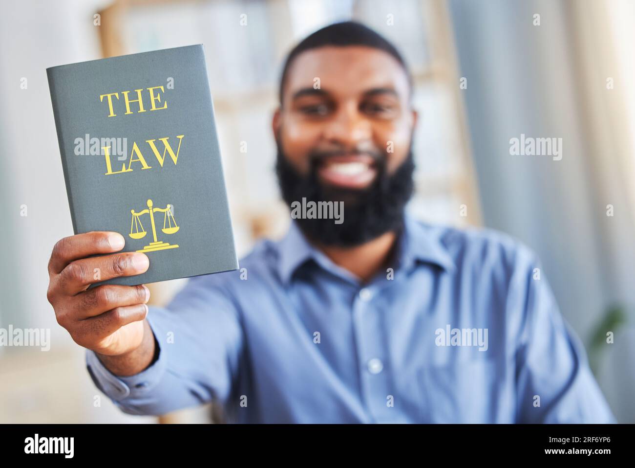Law, book and happy portrait of a man with the rules or research on legal constitution, regulation or policy from government. African businessman Stock Photo