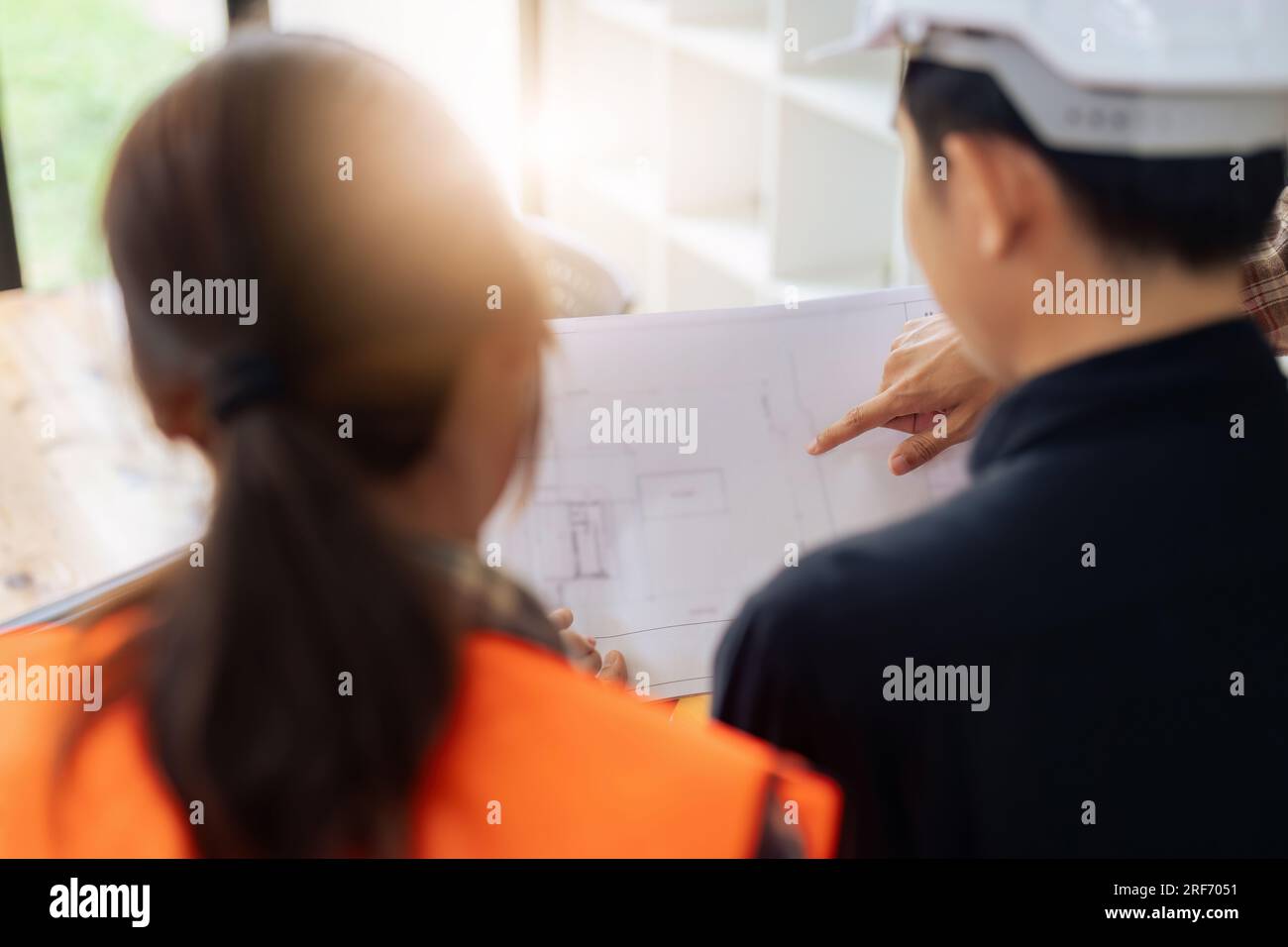Group of architects and engineers discuss about construction blueprint Stock Photo