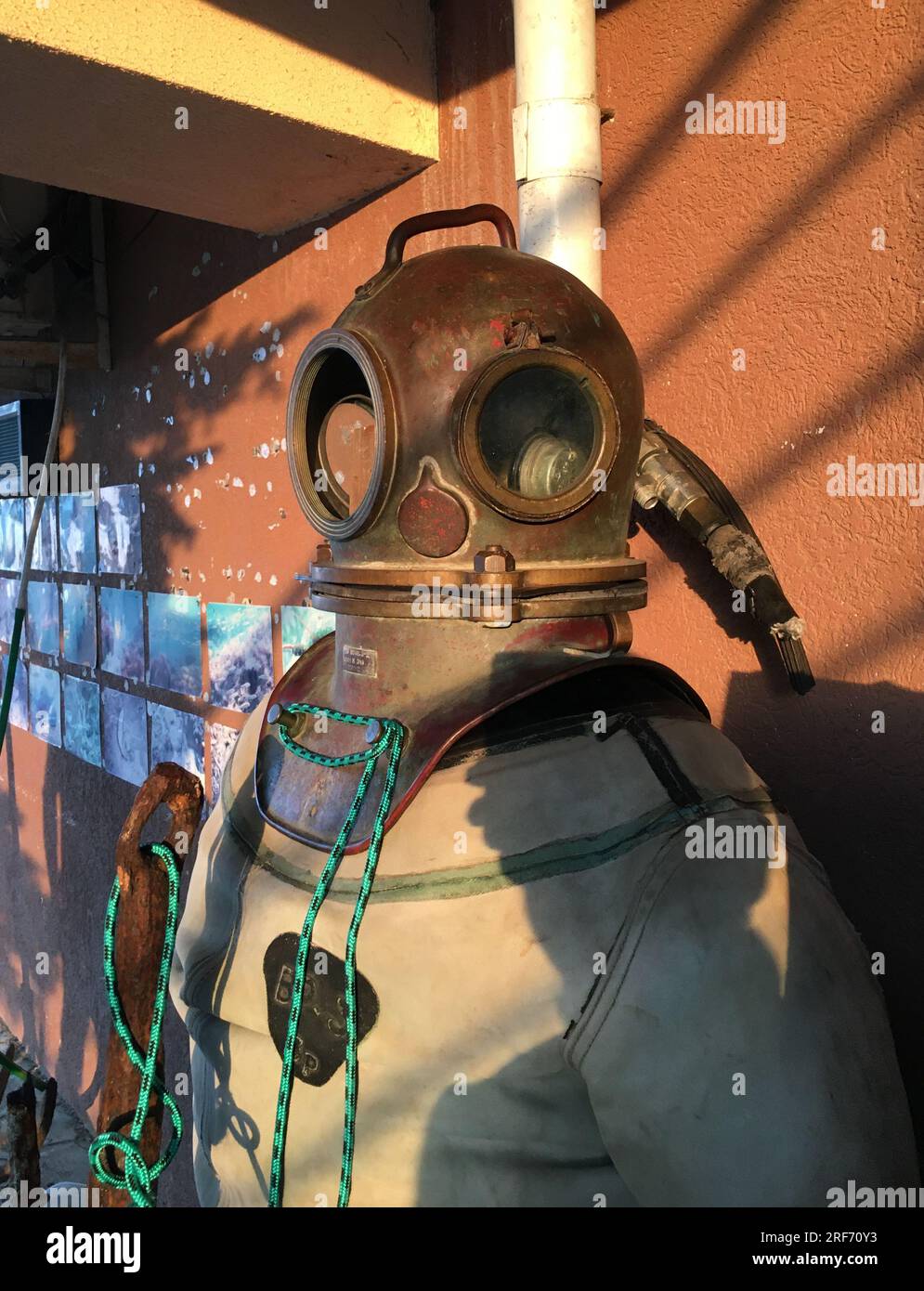 Anapa, Russia - June 16, 2023: Diving suit and helmet, old diving suit on the background of the wall in the seaport of Anapa. Stock Photo