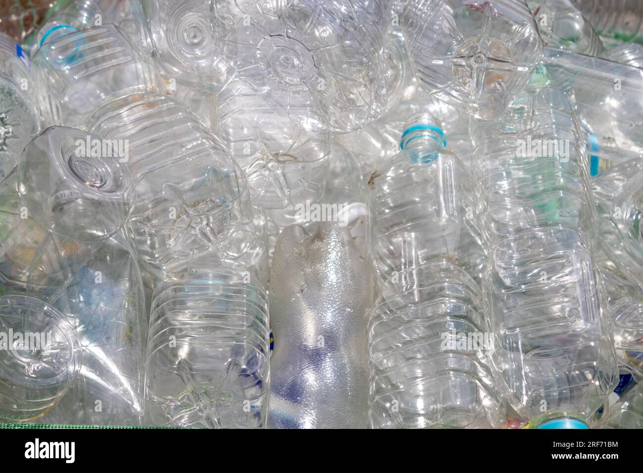 Many discarded clear plastic PET bottles in dumpster, Kanazawa, Japan